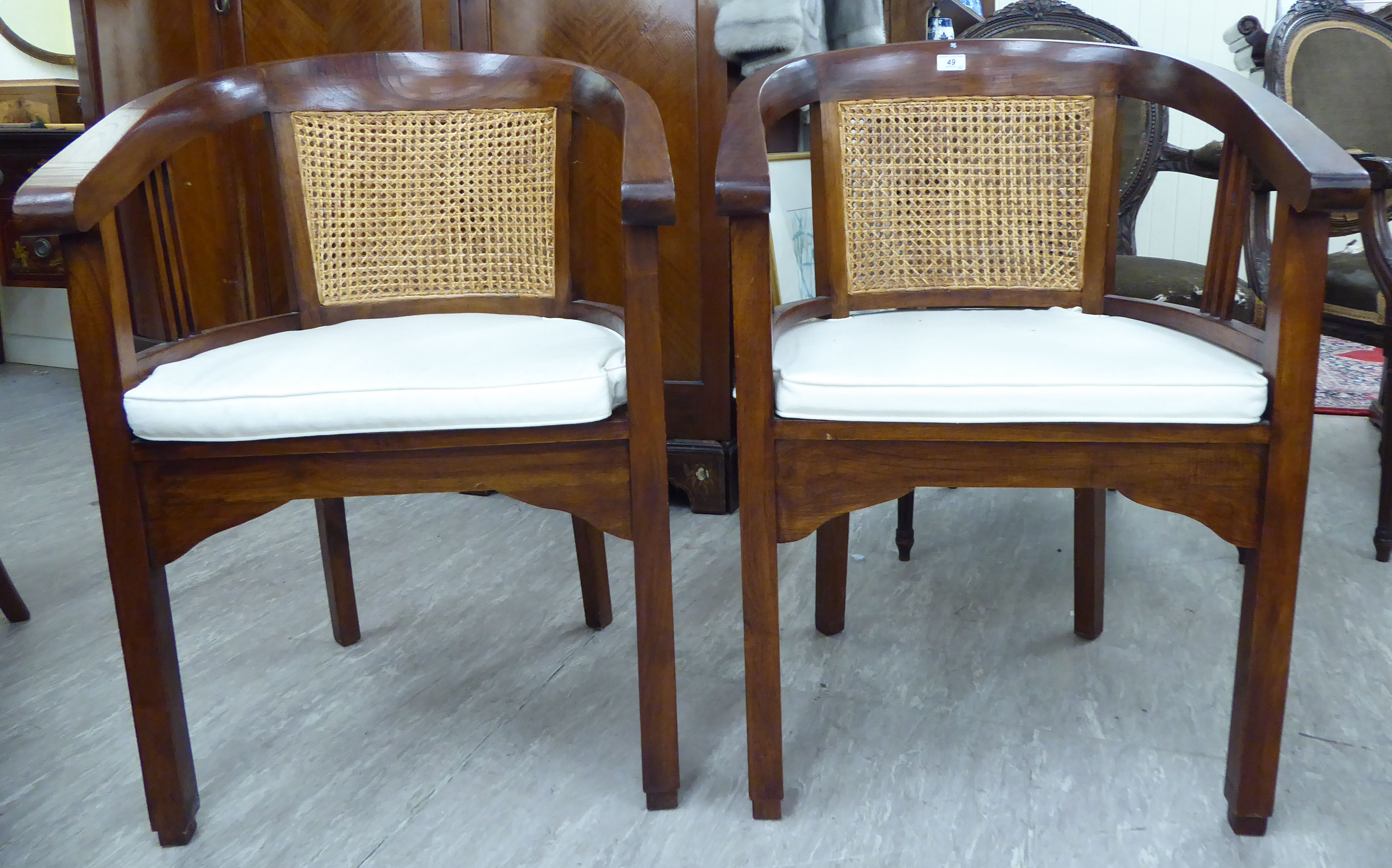 A pair of modern Chinese lacquered fruitwood framed officials' style horseshoe shaped chairs,