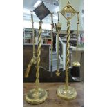 A pair of early 20thC lacquered brass fireside companions, each featuring two implement hooks,
