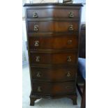 A modern mahogany finished serpentine front, six drawer dressing chest,