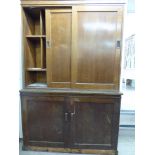 A 1930s butler's pantry design oak cabinet, the upper section with two sliding doors,