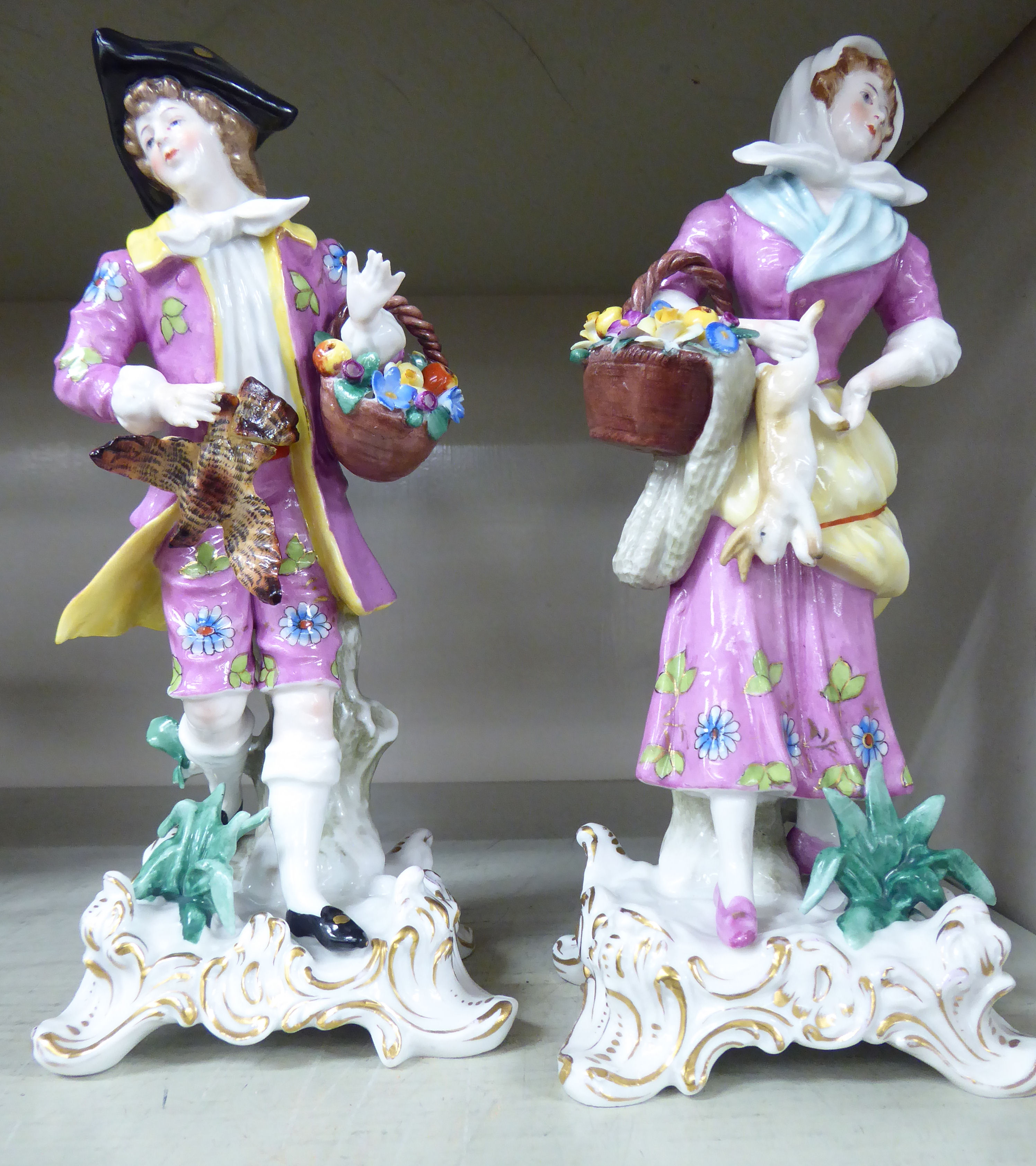 A pair of early 20thC Continental porcelain figures, a young man and woman,