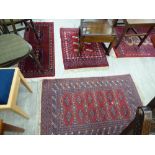 Four Persian rugs: to include a Bokhara with repeating elephant foot motifs on a red ground 46'' x
