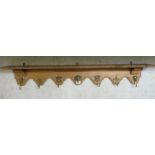 An early 20thC French light oak serpentine front wall shelf, on scrolled brackets,