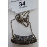 A silver coloured metal and marcasite pendant,