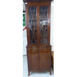 A mid 20thC Edwardian style mahogany cabinet bookcase with a moulded cornice,