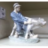 A Royal Copenhagen porcelain figure, a boy with a calf no.772 6.