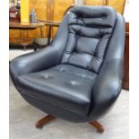 A designer chair, part button upholstered in faux black hide, raised on a splayed teak,