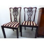 A pair of 1920s Georgian style Chippendale inspired mahogany framed dining chairs,