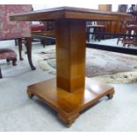 A mid 20thC light oak occasional table of square outline, raised on a straight column,