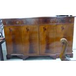 A modern string inlaid yew wood breakfront sideboard with three in-line frieze drawers,
