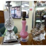 Three dissimilar glass table lamps, one in pink and misted blue of vase design 7.