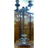 A late 19thC French cast bronze finished candelabrum with four foliate scrolled branches,