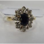 An 18ct gold sapphire and diamond set cluster ring 11