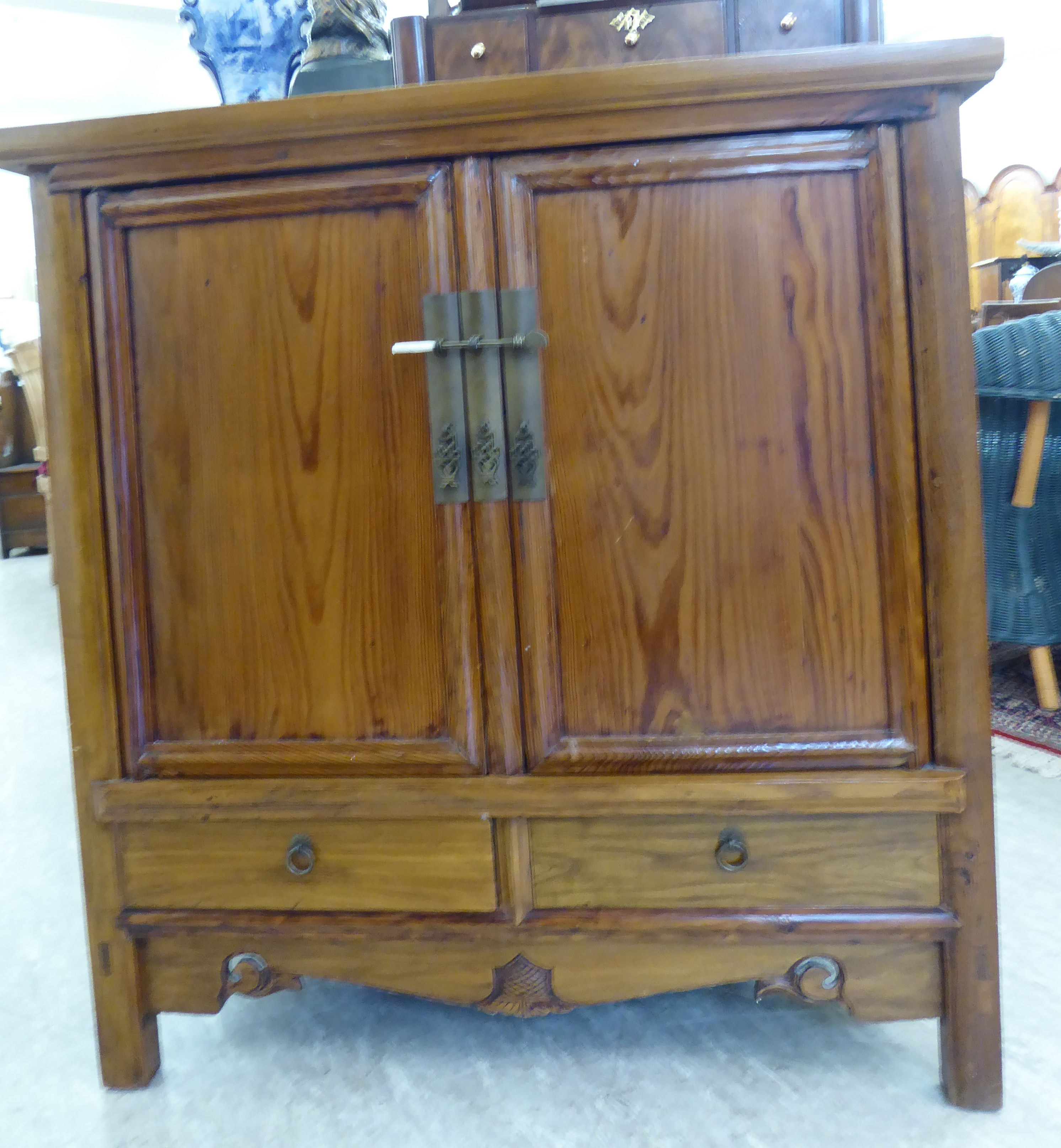 A modern Chinese lacquered elm cabinet, the top with a mitred edge,