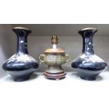 A pair of Oriental, black enamelled vases of squat bulbous form,