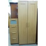 A modern light oak finished wardrobe with a pair of doors,