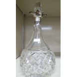 A hobnail and slice decorated glass liqueur decanter of bulbous form,