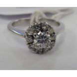 An 18ct white gold claw set diamond cluster ring 11