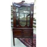 An early 19thC and later satinwood string inlaid mahogany two part display cabinet with a shaped