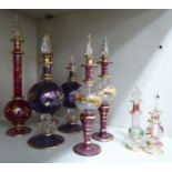 Three pairs of modern part lustre glass pedestal scent bottles with flame finials,