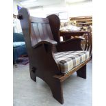 A mid 20thC oak and beech framed armchair, the fabric covered,