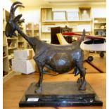 A patinated bronze sculpture, a stylised goat,