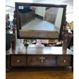 An early Victorian toilet mirror, the rectangular plate set in a mahogany frame, pivoting on angled,