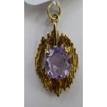 A 9ct textured gold and amethyst set pendant 11