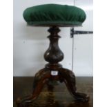 A late Victorian walnut framed, height adjustable, revolving piano stool,