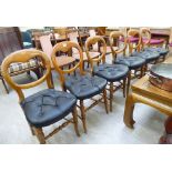 A set of six late Victorian stained beech framed balloon back dining chairs with faux hide