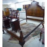 A mid 20thC Queen Anne inspired figured and crossbanded walnut bed frame with an arched headboard,