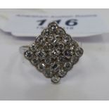 A white coloured metal diamond shaped set cluster ring stamped 'Plat' 11
