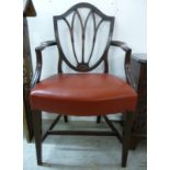 A 1920s Sheraton design mahogany framed shield back desk chair with a red hide upholstered seat,