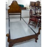 A mid 20thC Queen Anne inspired figured walnut bed frame with an arched headboard,