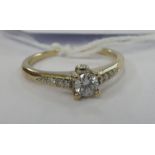 A gold coloured metal single stone diamond ring stamped 750 11