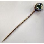 A yellow metal stickpin,