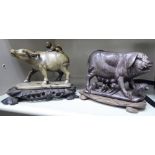 A 20thC Chinese carved sage green soapstone model, a child on the back of a water buffalo,