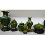 Six dissimilar, modern Oriental cloisonne vases, some with covers and wooden stands,