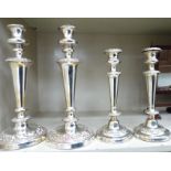 Two similar pairs of 19thC style silver plated candlesticks with foliate ornament,