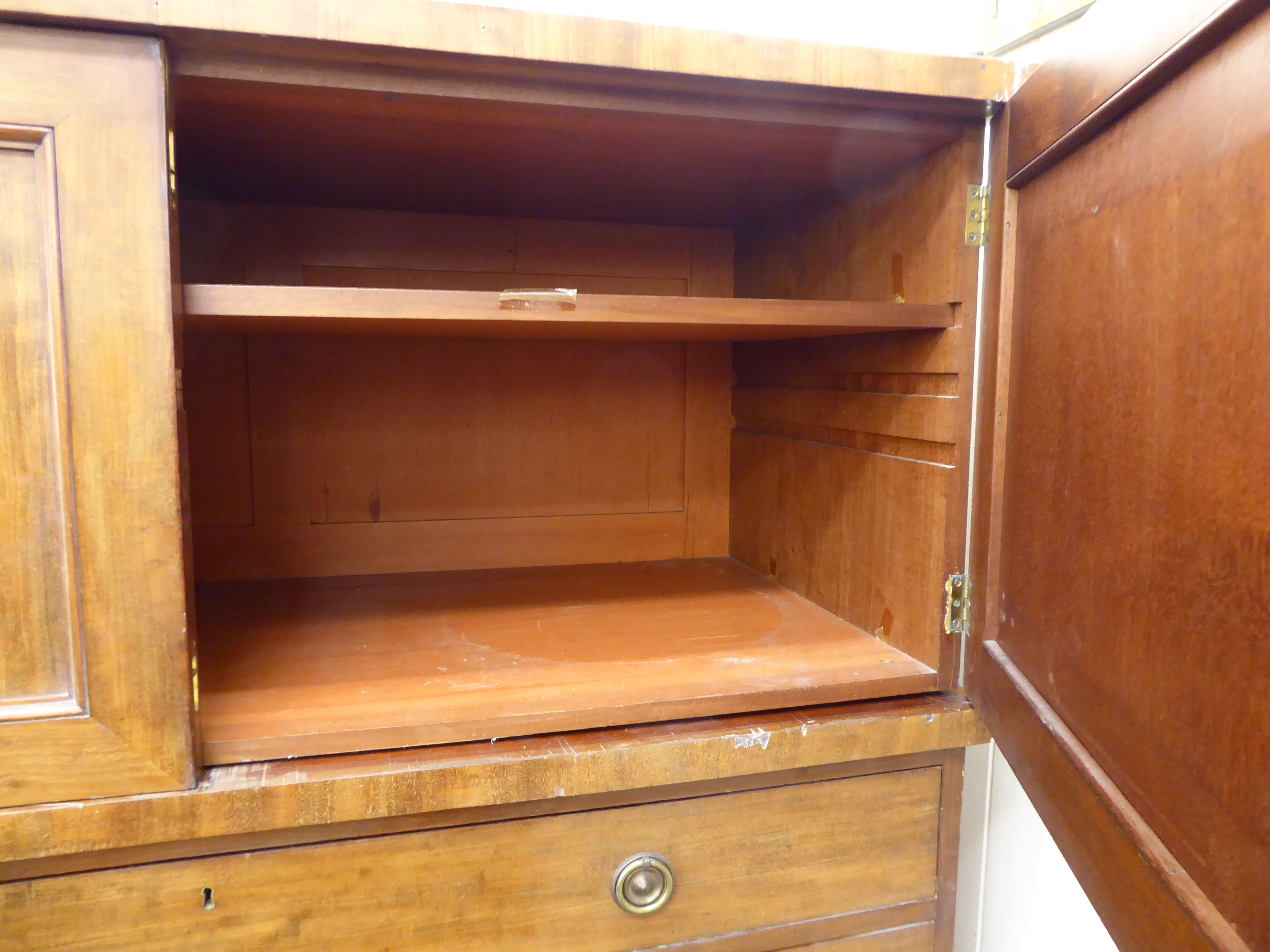 A mid 19thC mahogany linen chest with a pair of panelled doors, over five graduated drawers, - Image 2 of 2