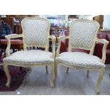 A pair of modern Louis XV design cream painted showwood framed salon chairs,