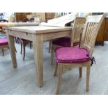 A modern rustically constructed, limed hardwood dining table with a parquet effect top,
