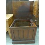 A late Victorian mahogany 'night commode' cabinet with a rising top and panelled front,