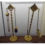 A pair of early 20thC lacquered brass fireside companions, each featuring two implement hooks,