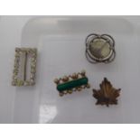 Four dissimilar brooches,