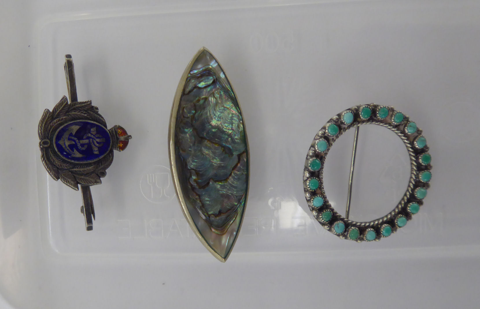 Three dissimilar brooches,