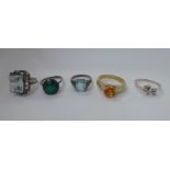 Five dissimilar and variously set silver coloured metal and other rings 11