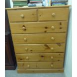 A modern honey coloured pine dressing chest,