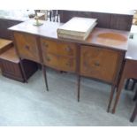 A modern Georgian style mahogany finished serpentine front sideboard with two drawers and two flank