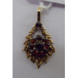 A 9ct gold foliate and garnet set pendant 11